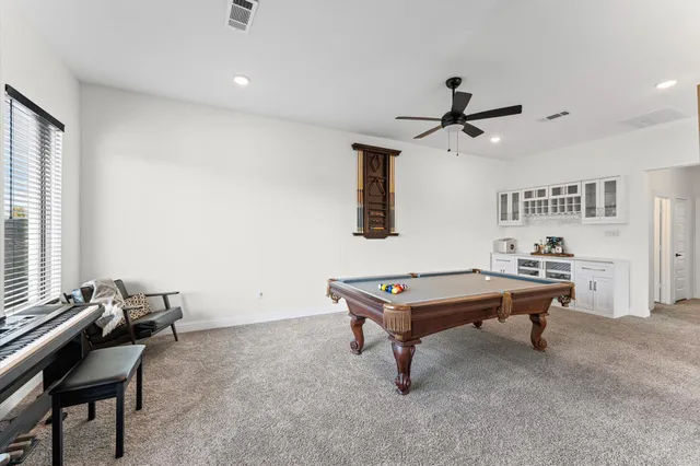 a room with table chairs and windows