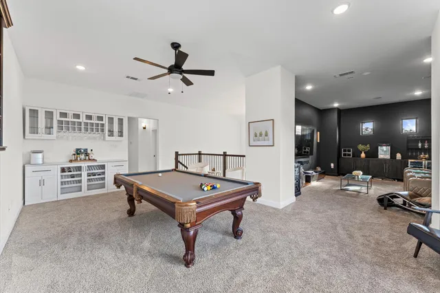 a living room with furniture a table and gym equipment