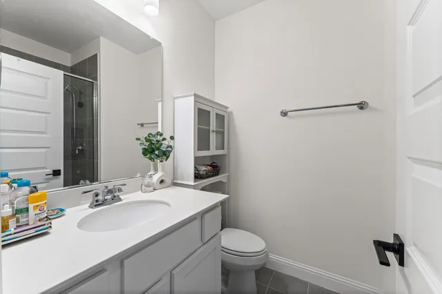 a bathroom with a sink toilet and a mirror