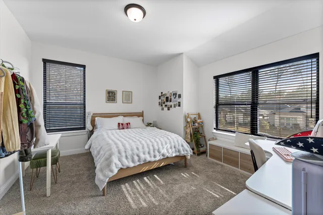 a bedroom with a bed and a large window