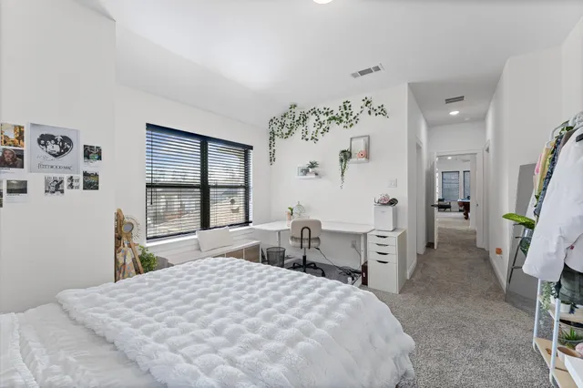 a bedroom with a large bed and a large window