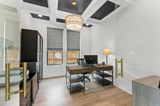 a view of a workspace with furniture and a window