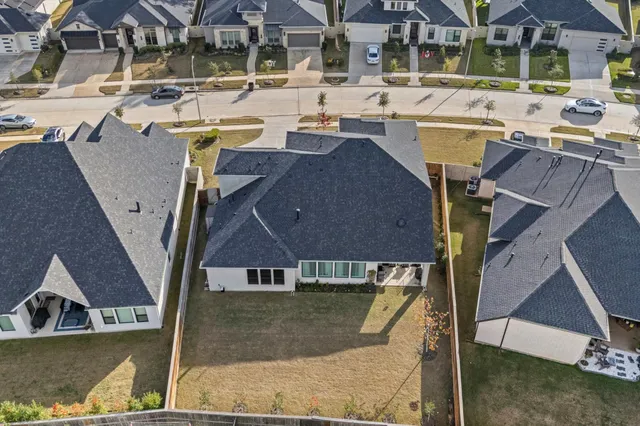 a view of a house with pool and chairs