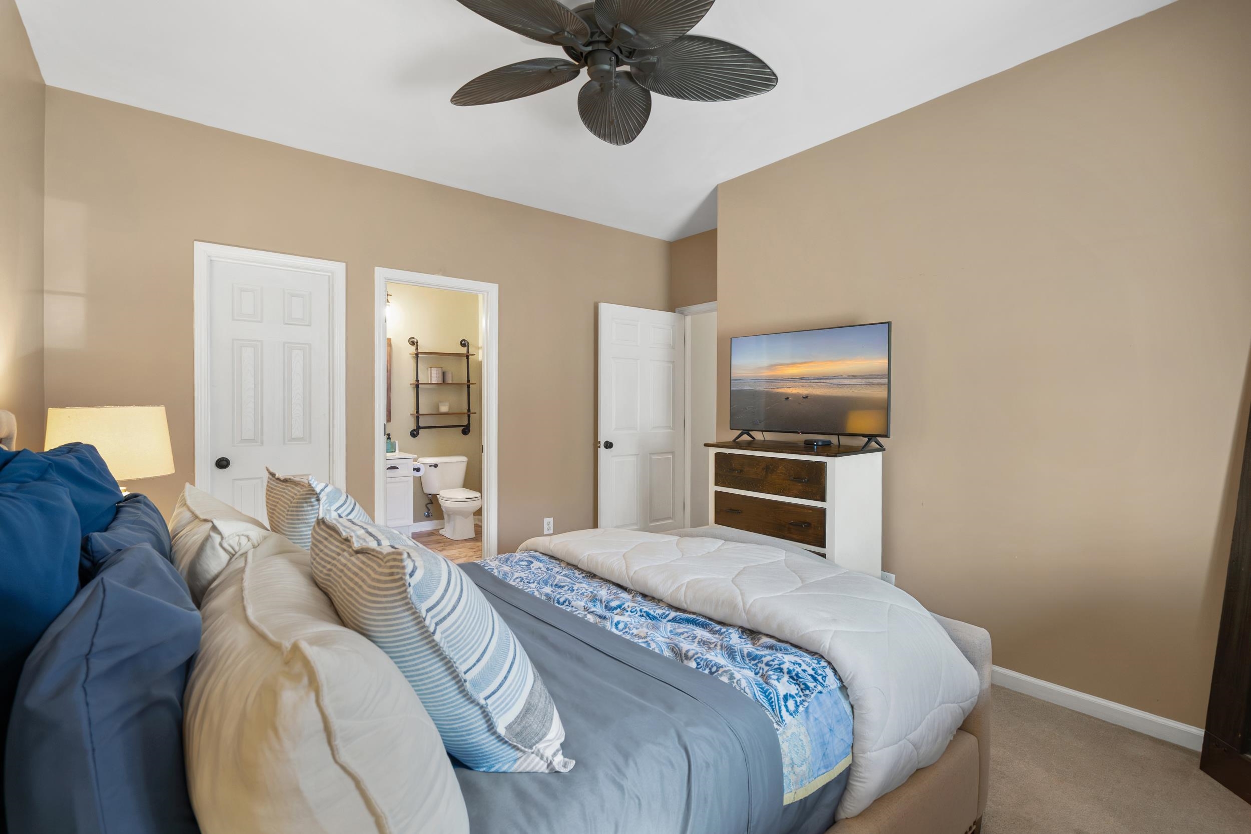 4436 Lady Banks Lane, Unit B2 Murrells Inlet, SC 29576 - Photo 15 of 36 Carpeted bedroom featuring ensuite bath and ceiling fan