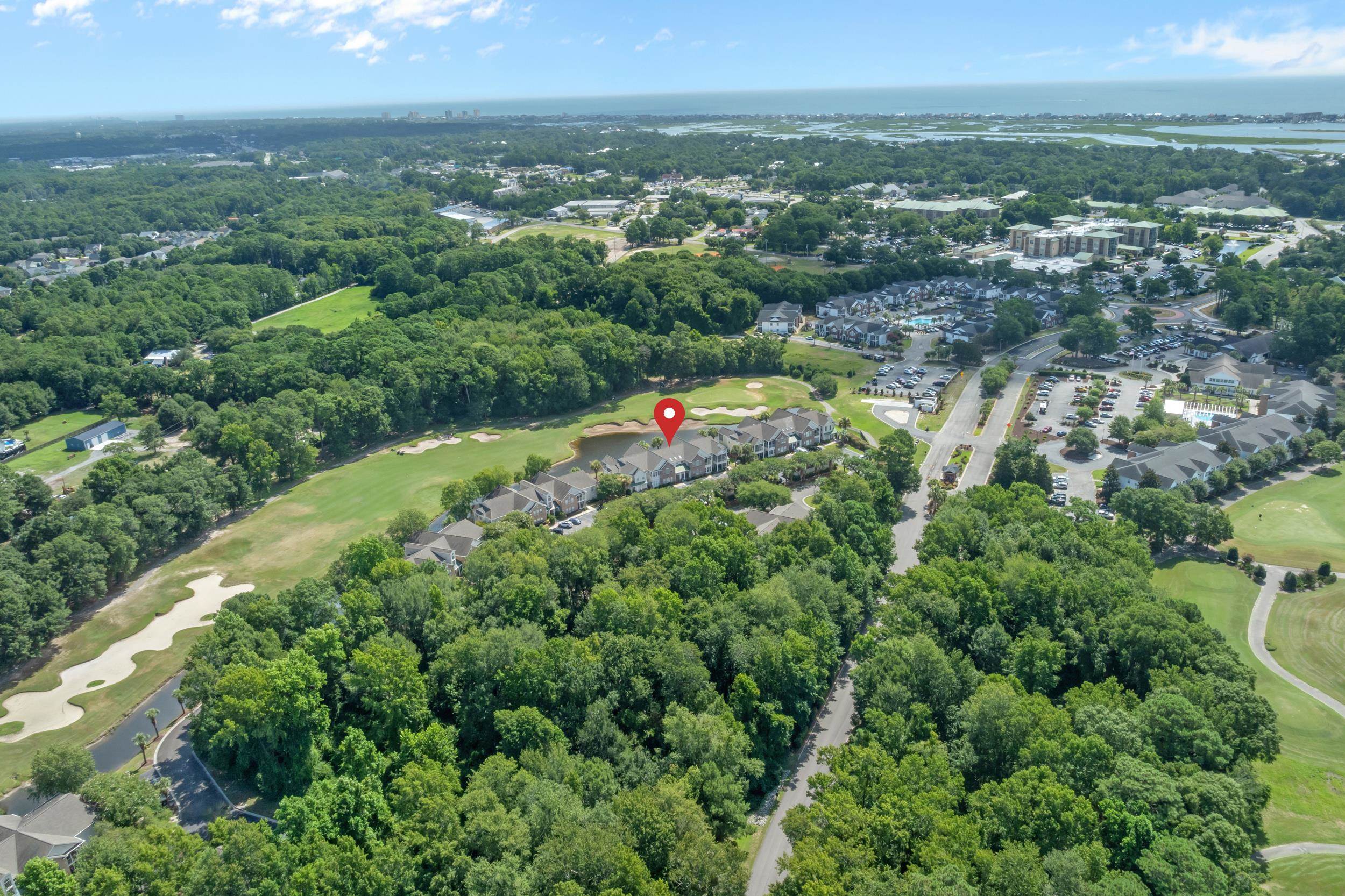 4436 Lady Banks Lane, Unit B2 Murrells Inlet, SC 29576 - Photo 27 of 36 Aerial overview of property's location featuring a golf course and a large body of water