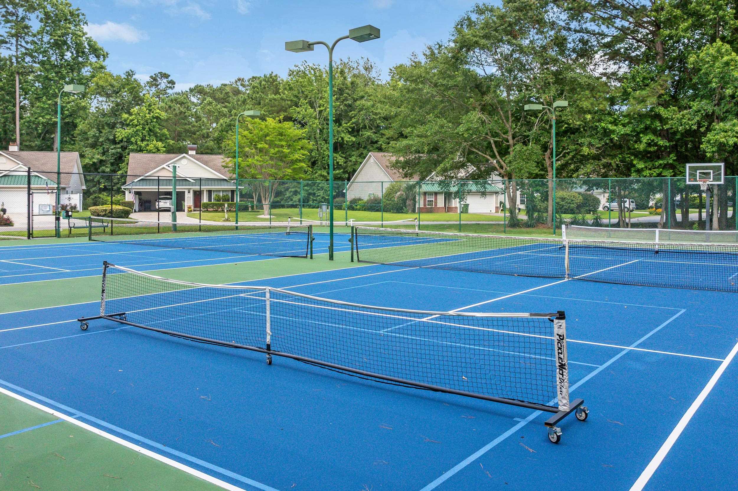 4436 Lady Banks Lane, Unit B2 Murrells Inlet, SC 29576 - Photo 31 of 36 View of tennis court with community basketball court and view of wooded area