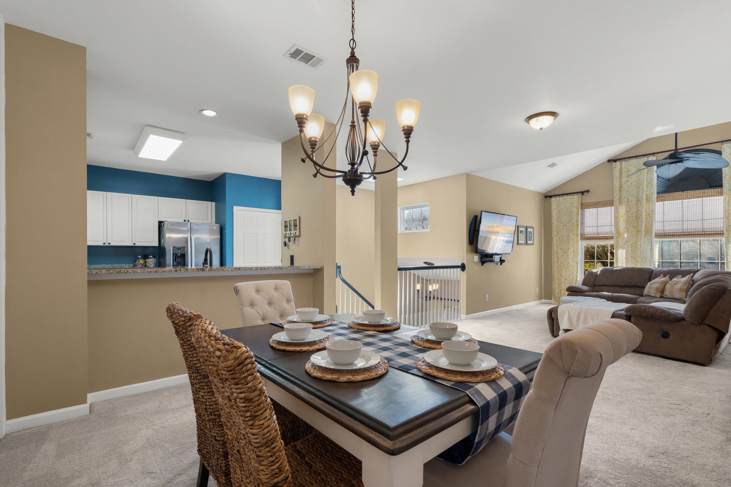 4436 Lady Banks Lane, Unit B2 Murrells Inlet, SC 29576 - Photo 8 of 36 Dining room with light colored carpet, a chandelier, and vaulted ceiling