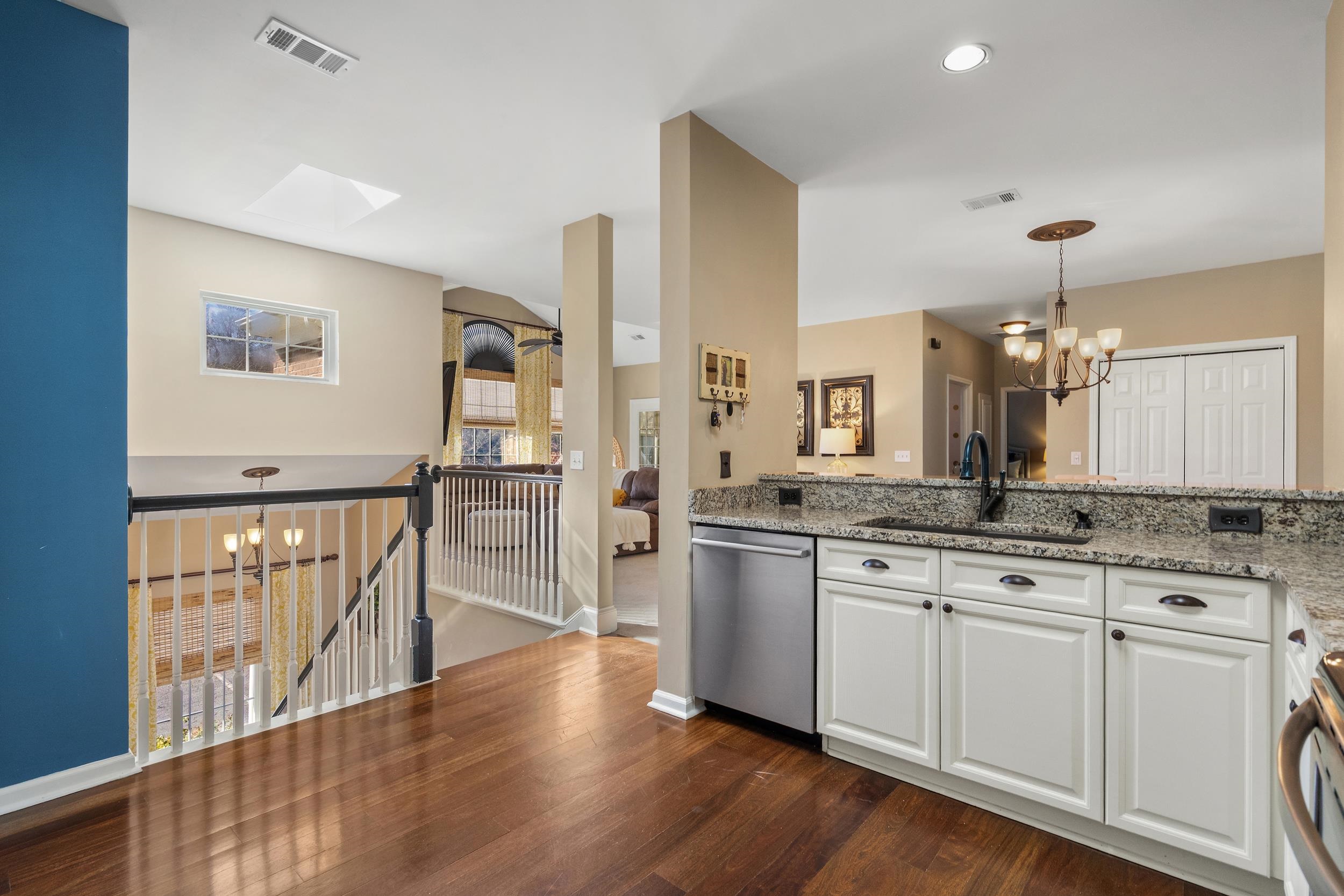 4436 Lady Banks Lane, Unit B2 Murrells Inlet, SC 29576 - Photo 9 of 36 Kitchen featuring a chandelier, appliances with stainless steel finishes, light stone counters, and pendant lighting