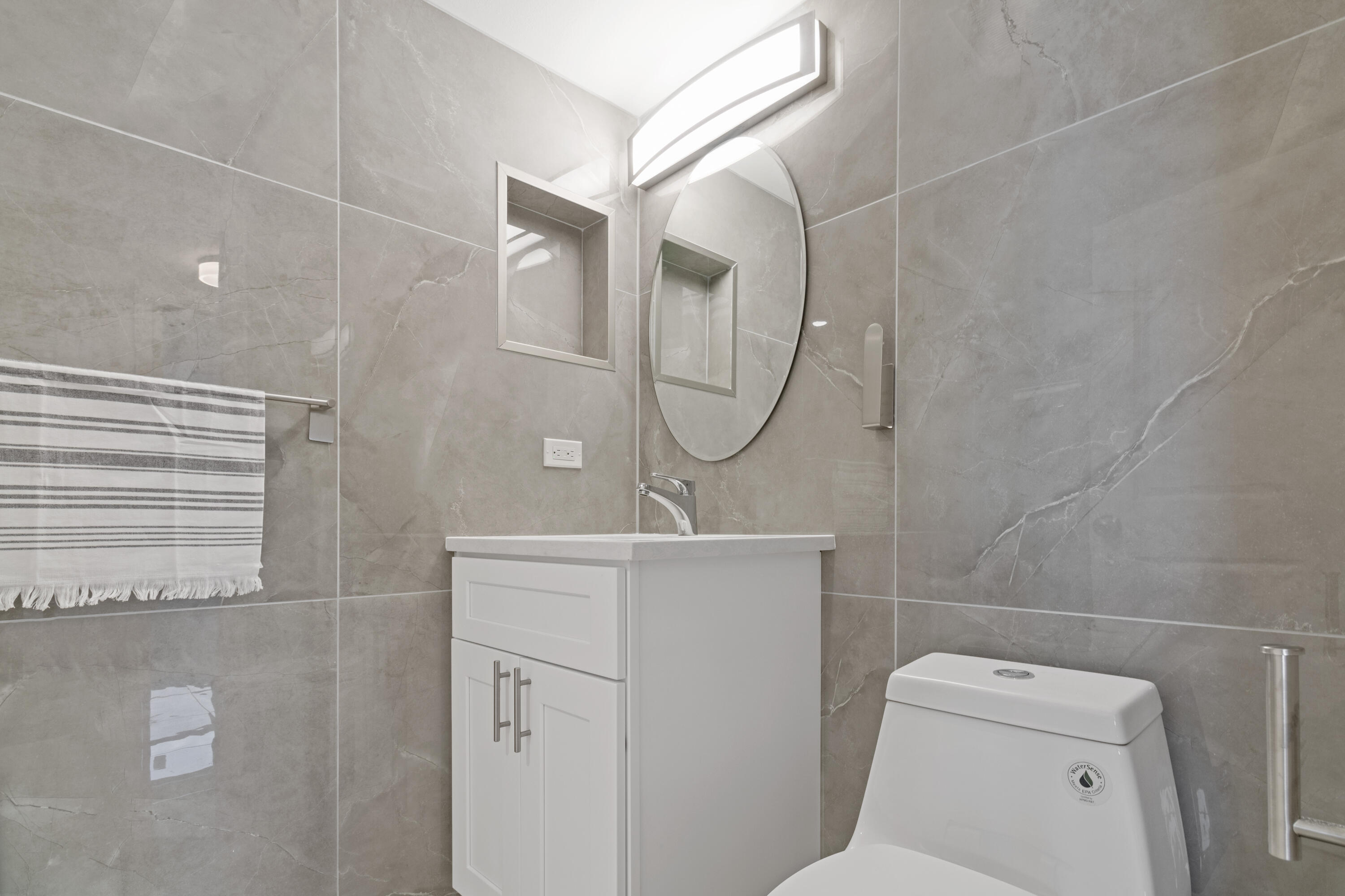 1200 Marine Way, Unit 802 North Palm Beach, FL 33408 - Photo 20 of 34 a bathroom with a sink a toilet and a mirror