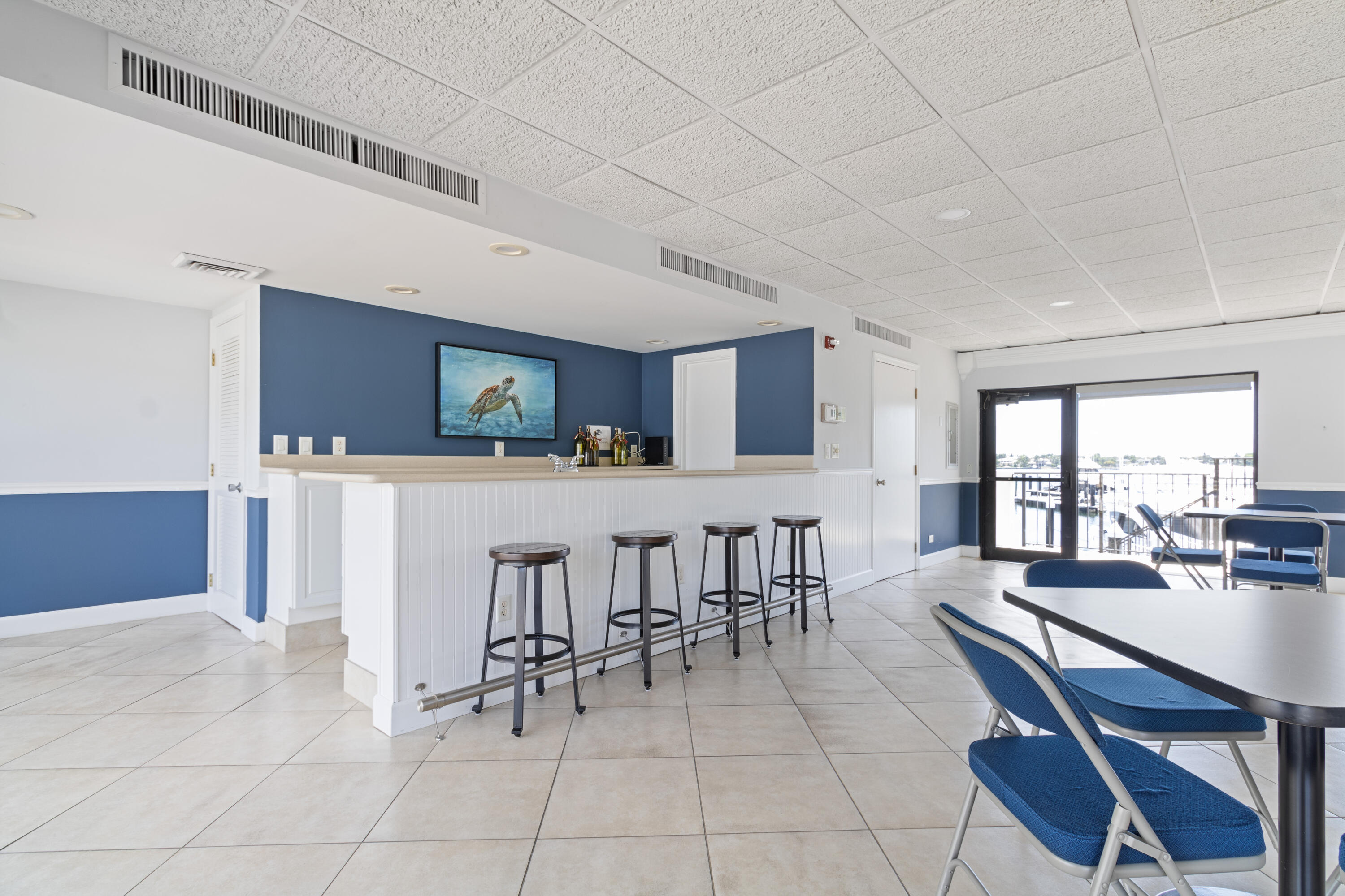 1200 Marine Way, Unit 802 North Palm Beach, FL 33408 - Photo 26 of 34 a dining hall with stainless steel appliances kitchen island granite countertop a dining table chairs and view living room