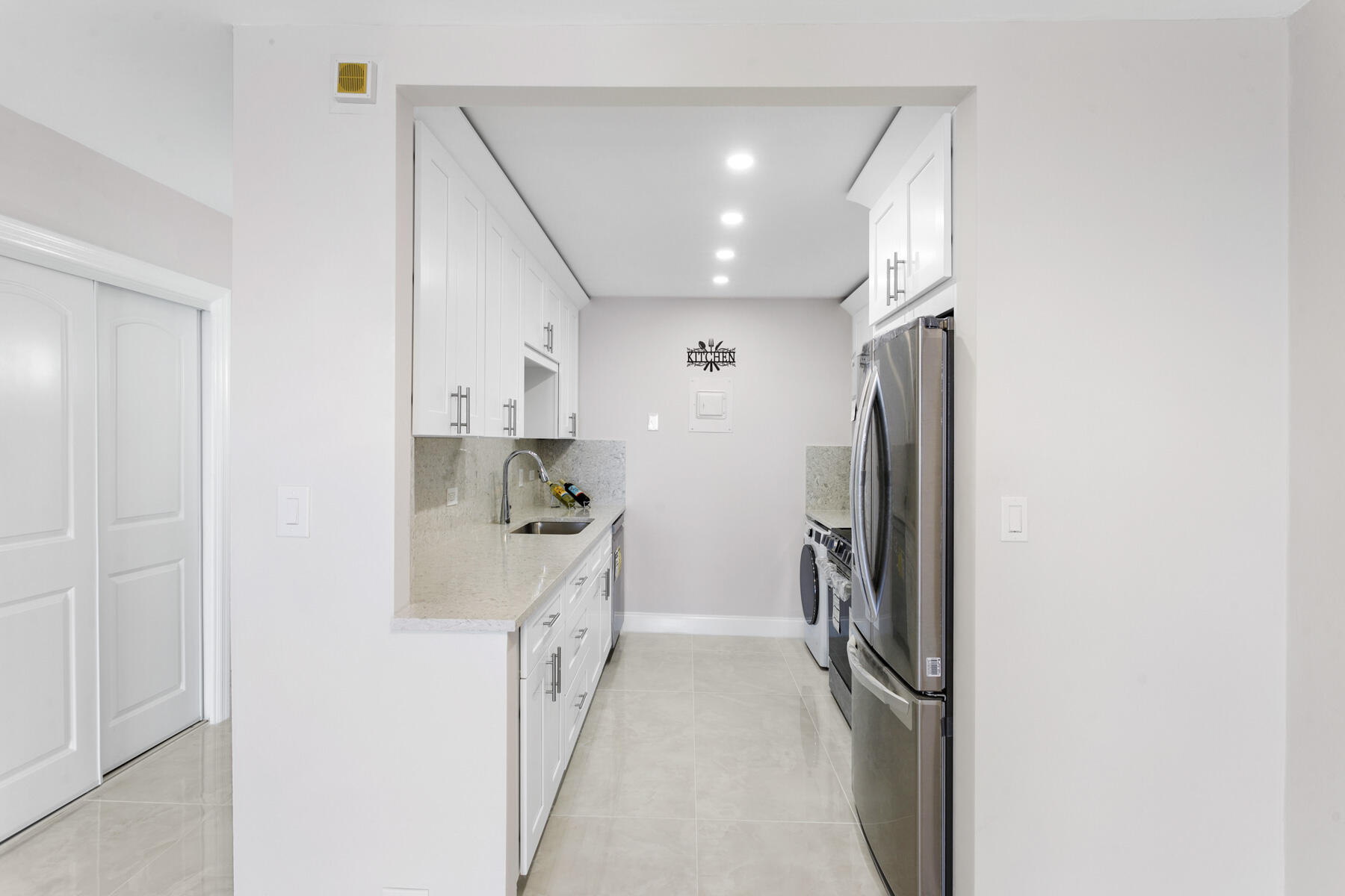 1200 Marine Way, Unit 802 North Palm Beach, FL 33408 - Photo 5 of 34 a kitchen with a refrigerator and a sink