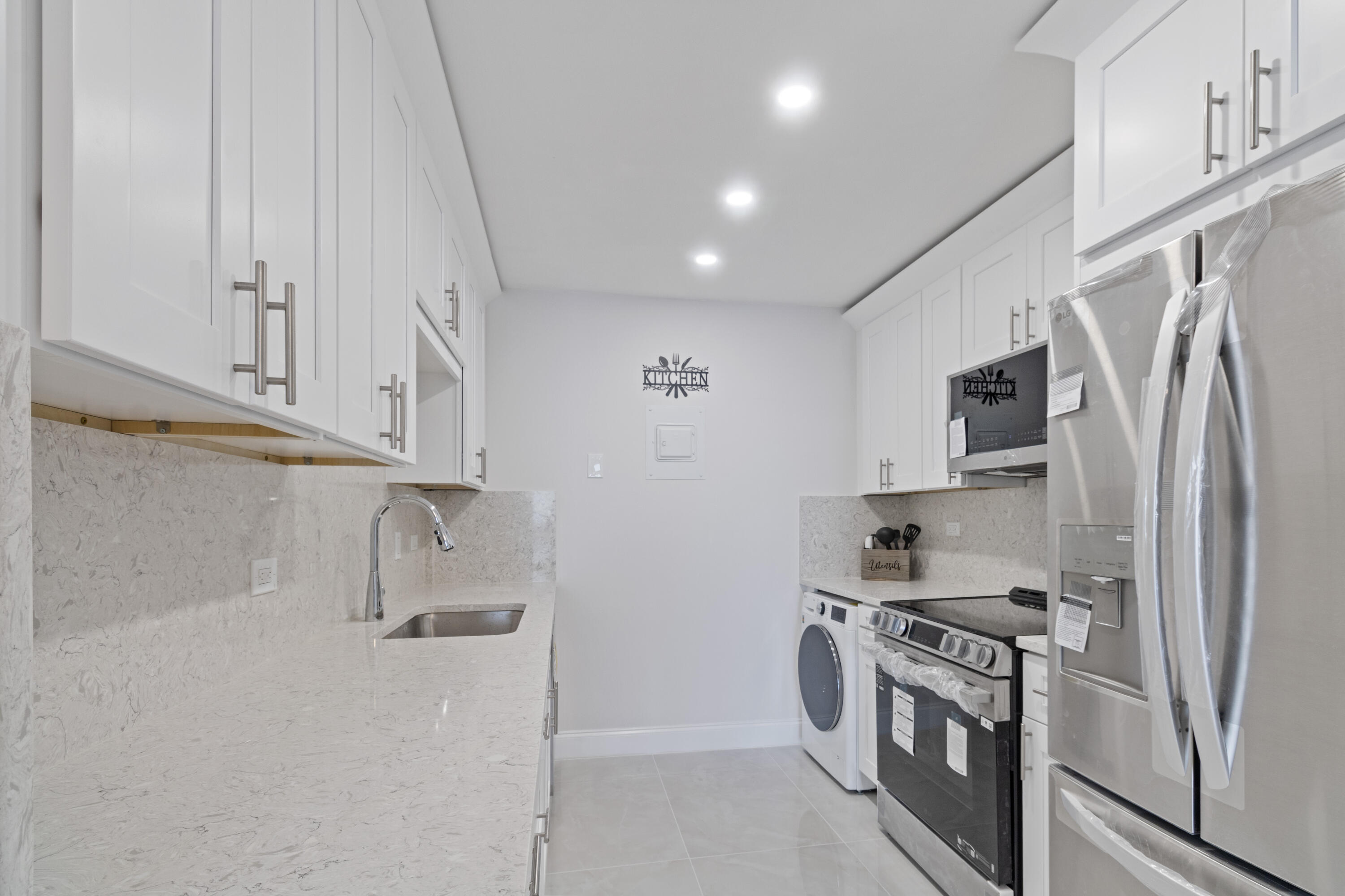 1200 Marine Way, Unit 802 North Palm Beach, FL 33408 - Photo 6 of 34 a kitchen with stainless steel appliances granite countertop a refrigerator a stove and a sink