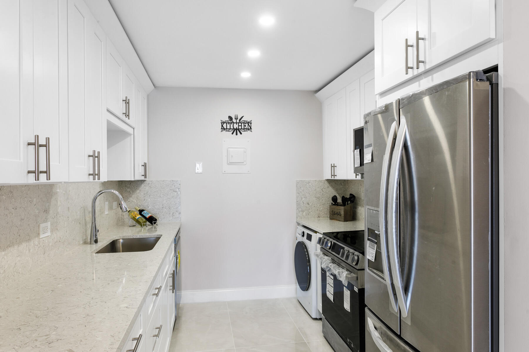 1200 Marine Way, Unit 802 North Palm Beach, FL 33408 - Photo 7 of 34 a kitchen with a refrigerator and a sink