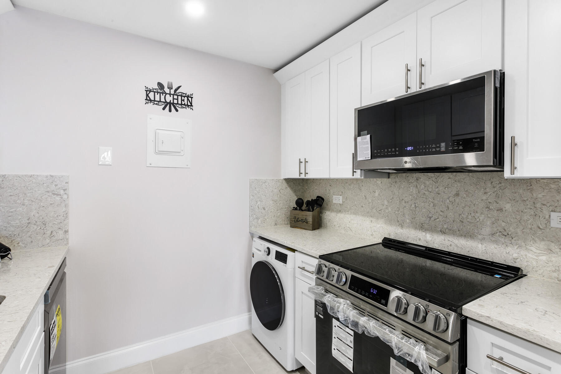 1200 Marine Way, Unit 802 North Palm Beach, FL 33408 - Photo 8 of 34 a kitchen with a stove and a microwave