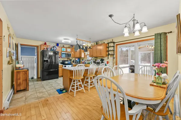 a dining room with furniture a chandelier and wooden floor