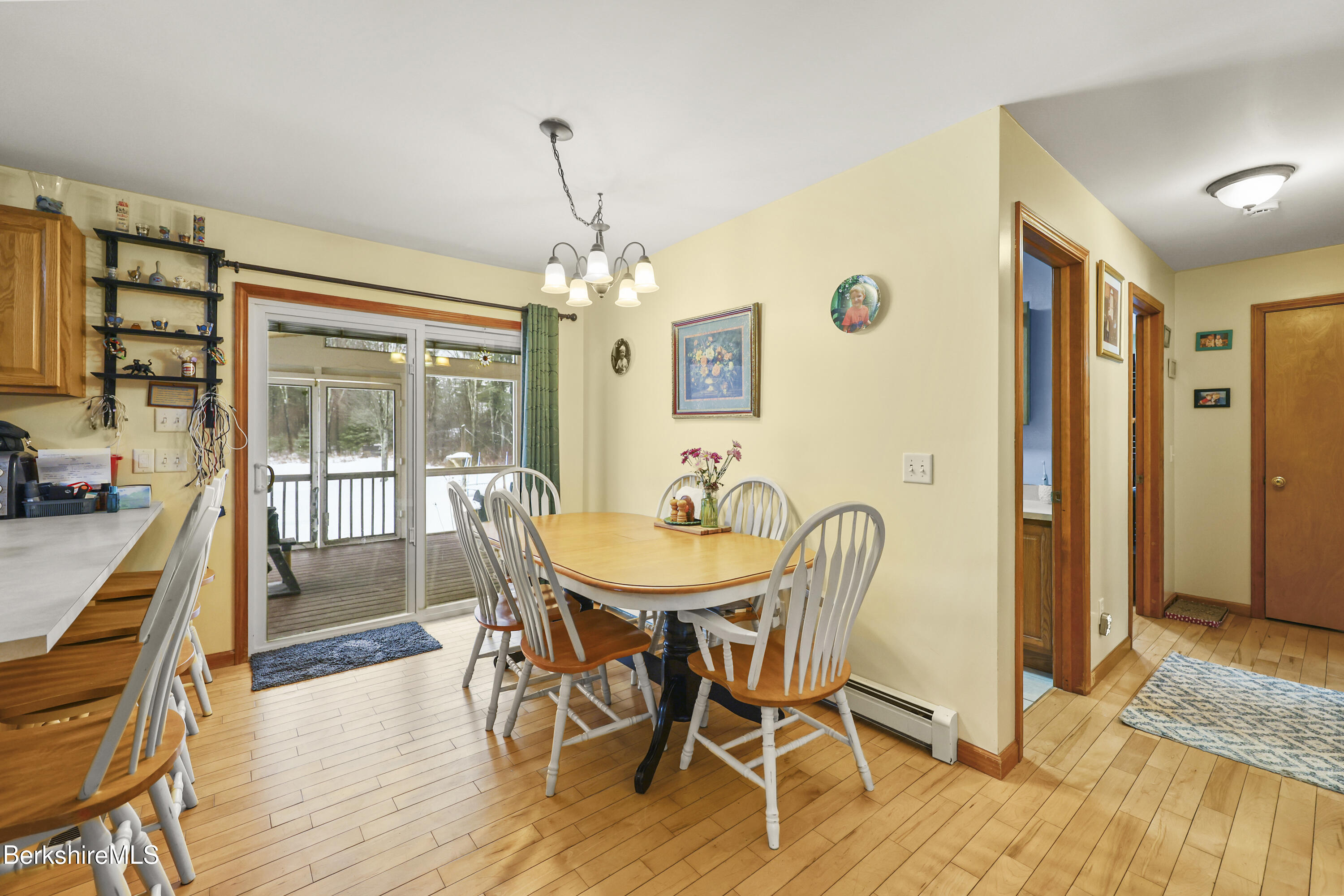 121 W Road Lee, MA 01238 - Photo 12 of 48 a dining room with furniture a chandelier and wooden floor