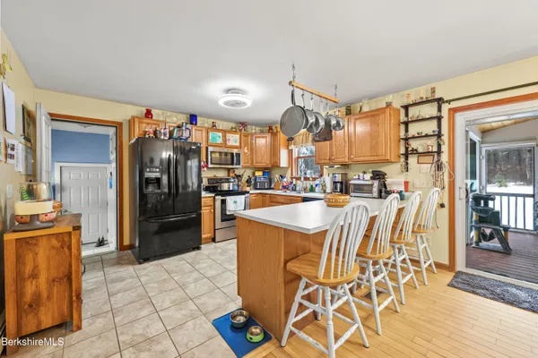 a view of a kitchen with furniture and wooden floor