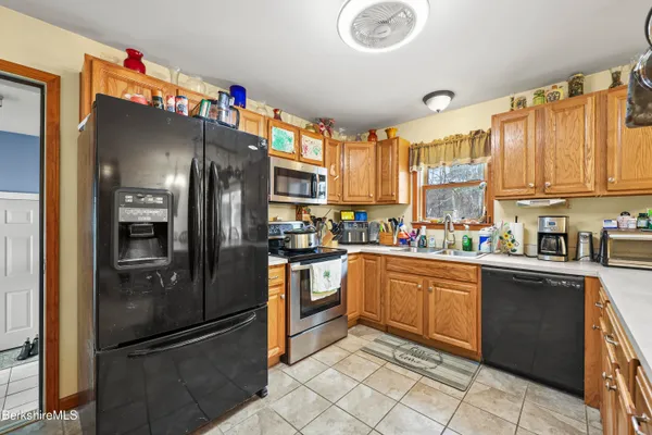 a kitchen with granite countertop stainless steel appliances and refrigerator