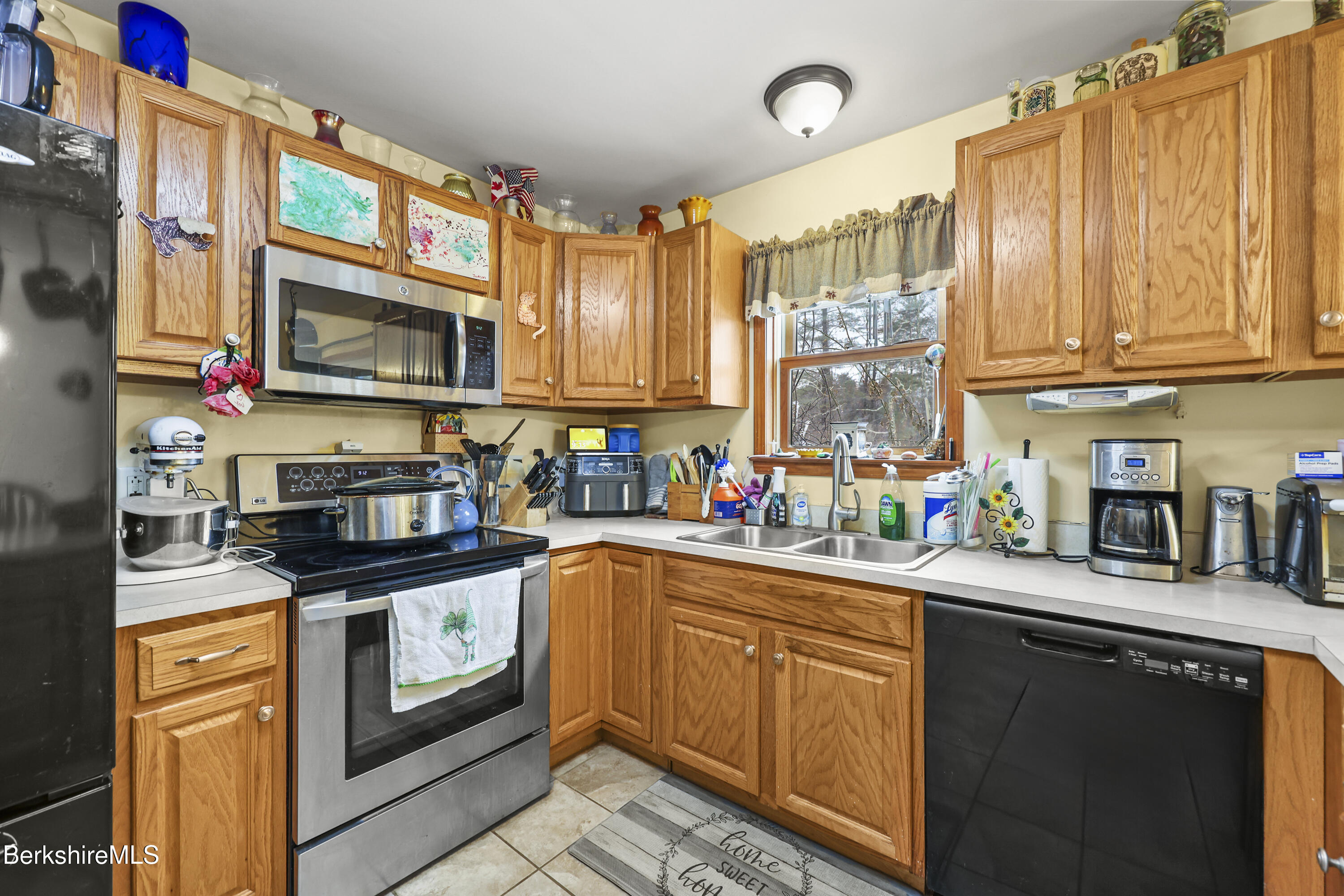121 W Road Lee, MA 01238 - Photo 16 of 48 a kitchen with stainless steel appliances granite countertop a sink a stove and cabinets