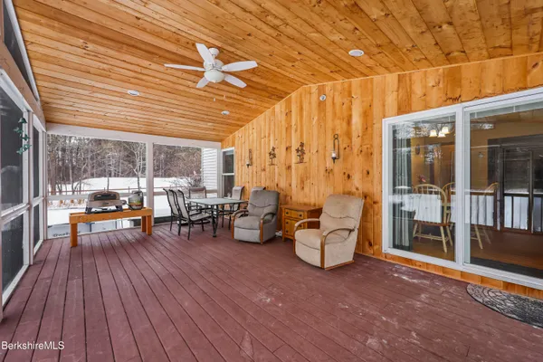 a view of a patio with chairs and potted plants
