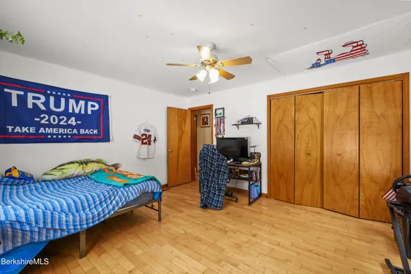 a bedroom with a bed and a desk