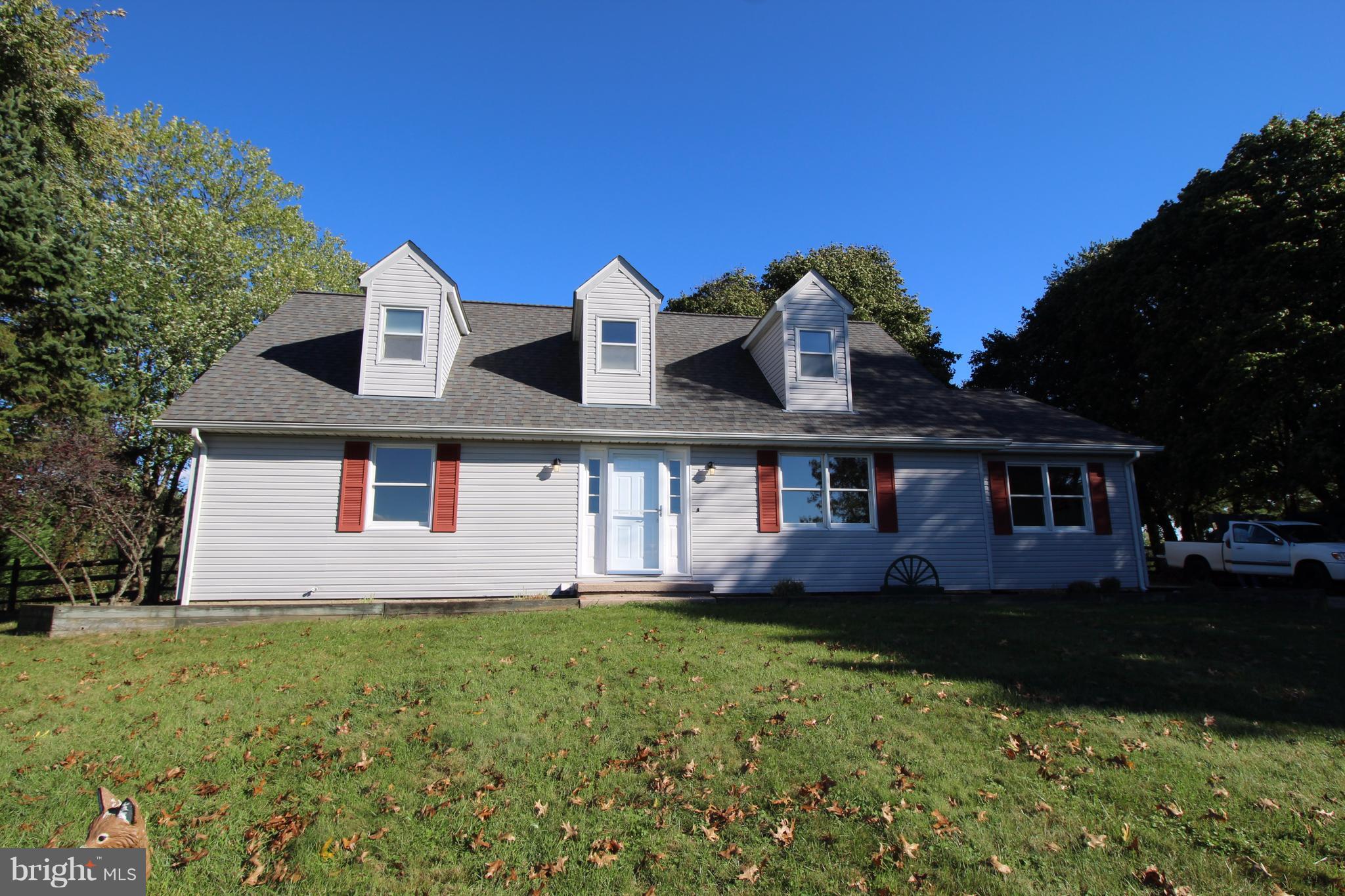 a front view of house with yard and green space