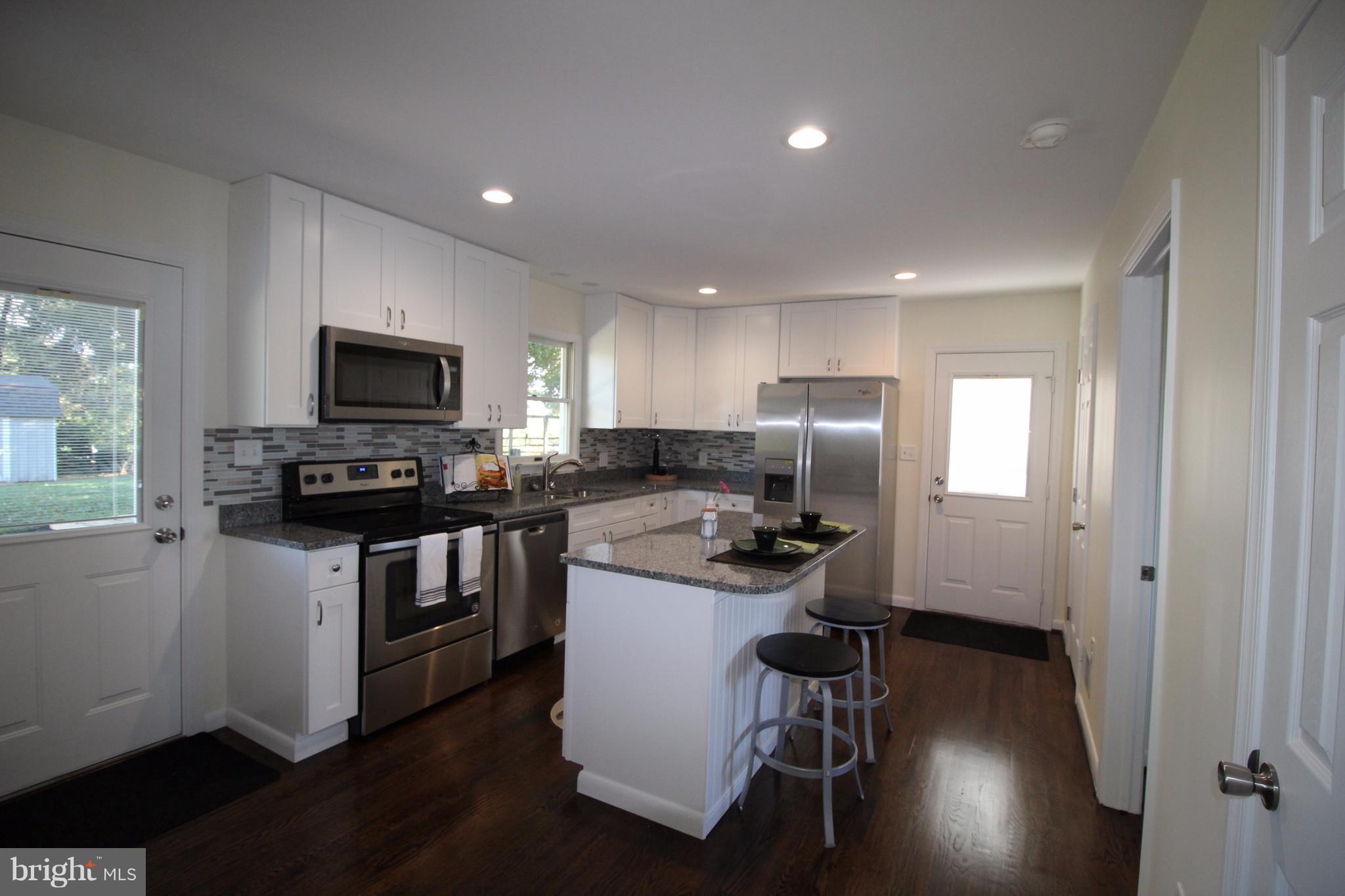 12805 Bunker Hill Road Union Bridge, MD 21791 - Photo 9 of 30 a kitchen with a sink stainless steel appliances and wooden floor