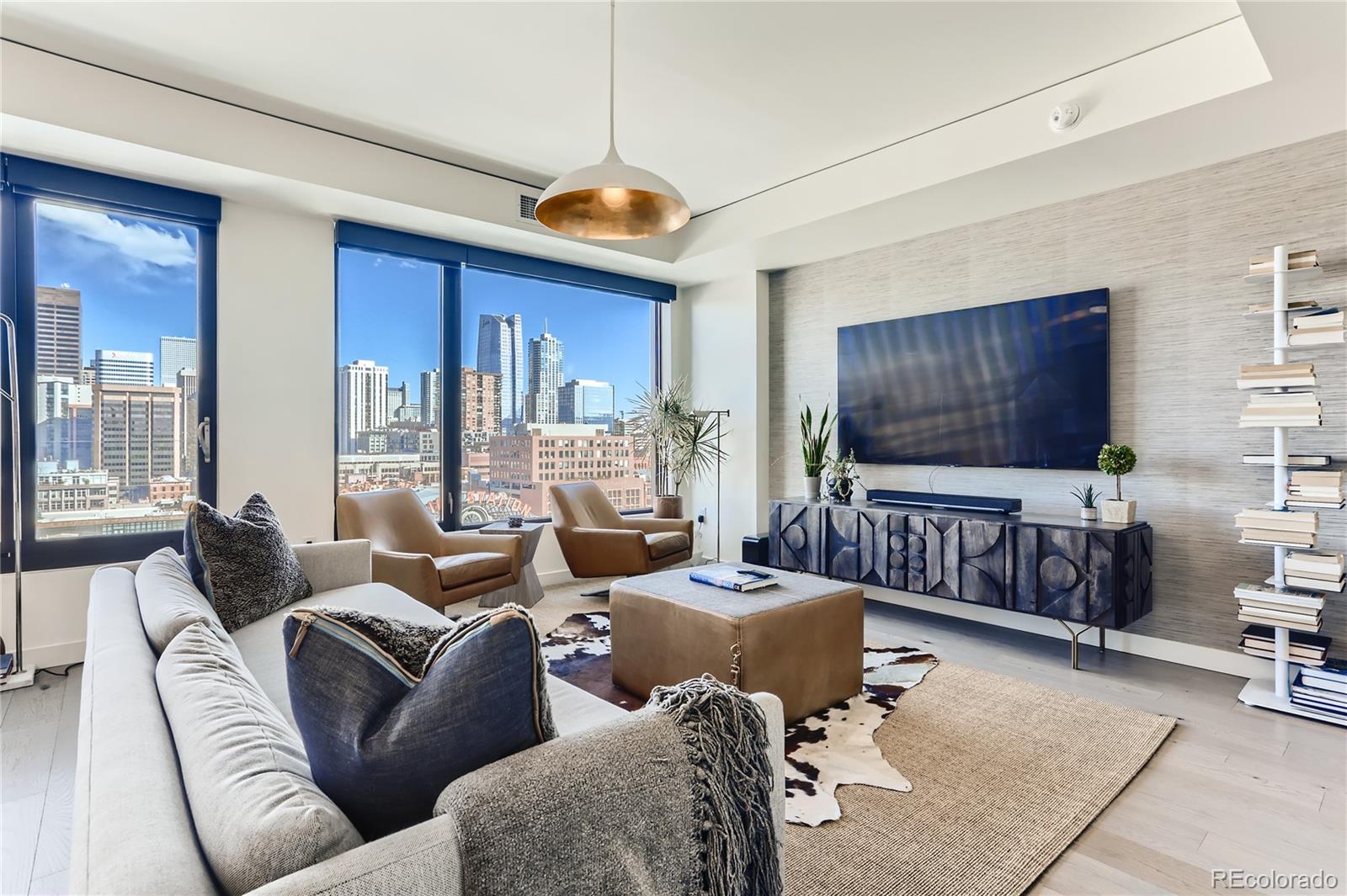 1750 Wewatta Street, Unit 1202 Denver, CO 80202 - Photo 1 of 16 a living room with furniture and a flat screen tv