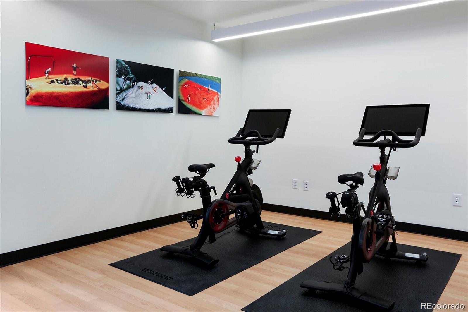 1750 Wewatta Street, Unit 1202 Denver, CO 80202 - Photo 14 of 16 a room with gym equipment and a flat screen tv