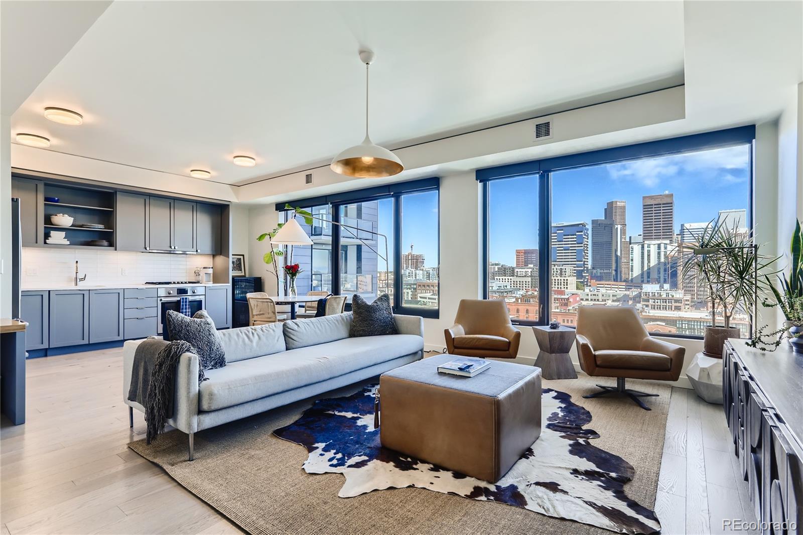 1750 Wewatta Street, Unit 1202 Denver, CO 80202 - Photo 2 of 16 a living room with furniture ceiling fan and a rug