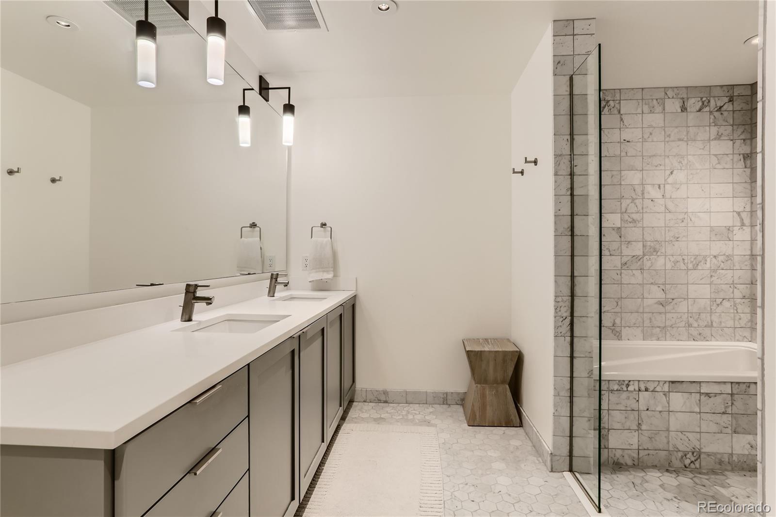 1750 Wewatta Street, Unit 1202 Denver, CO 80202 - Photo 9 of 16 a bathroom with a sink and a mirror