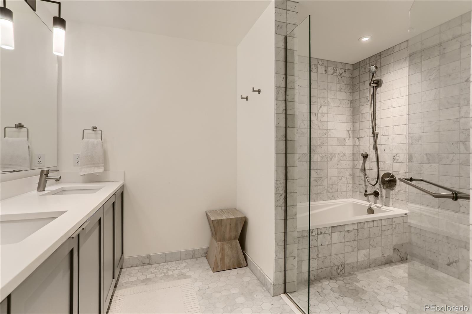 1750 Wewatta Street, Unit 1202 Denver, CO 80202 - Photo 10 of 16 a bathroom with a shower sink and mirror