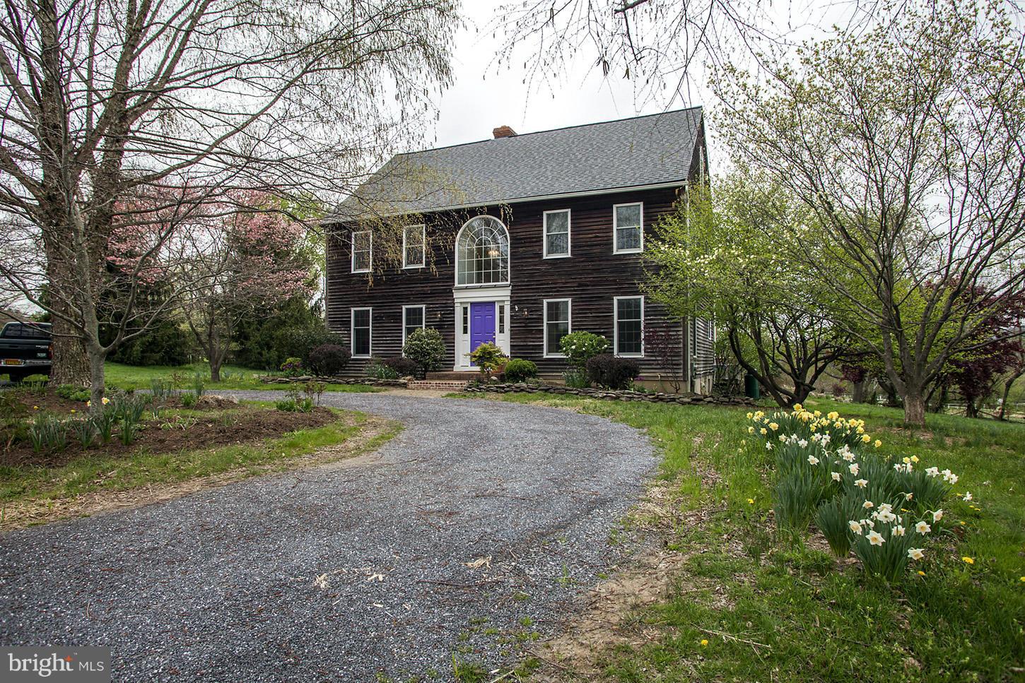 22316 West Harris Road Barnesville, MD 20838 - Photo 2 of 30 a front view of a house with a yard and trees
