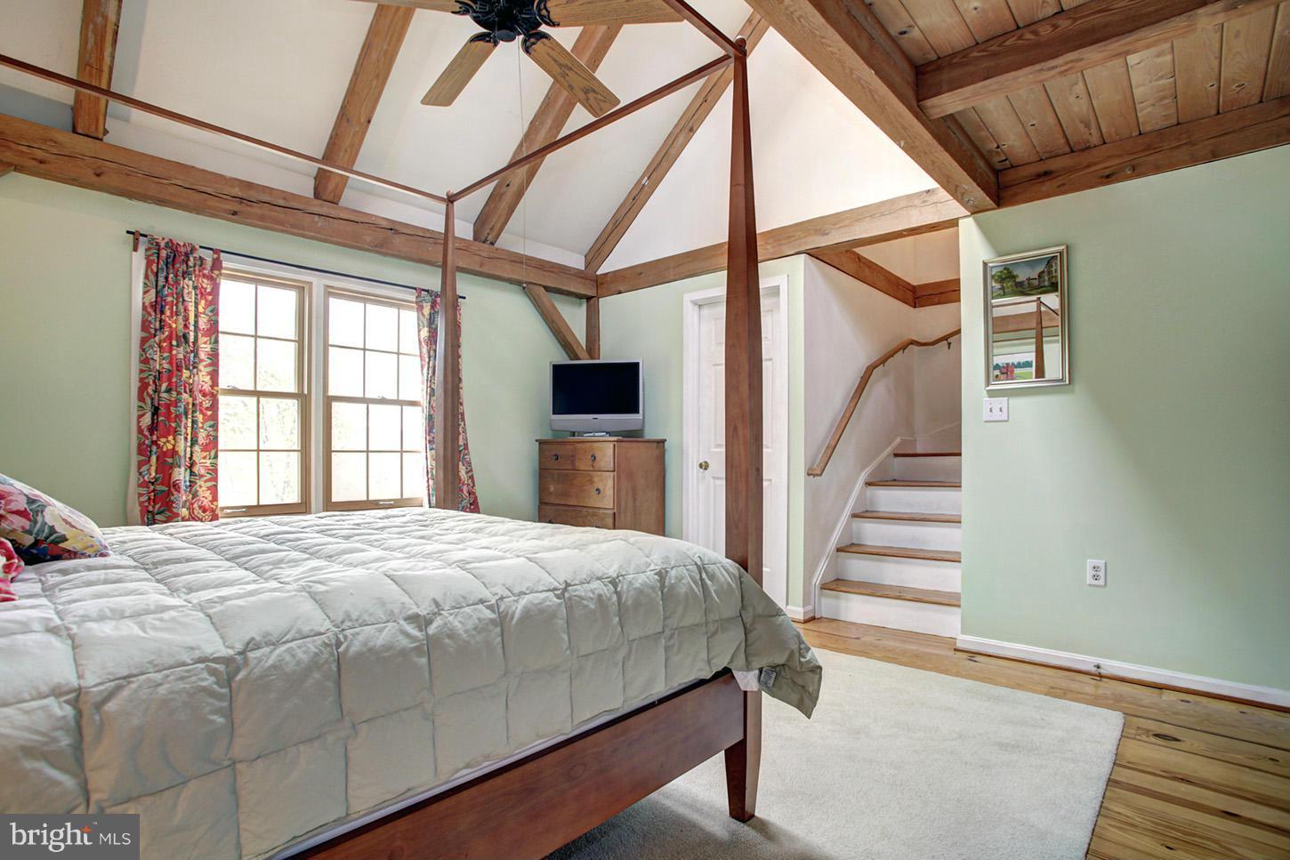 22316 West Harris Road Barnesville, MD 20838 - Photo 19 of 30 a bedroom with a bed and wooden floor
