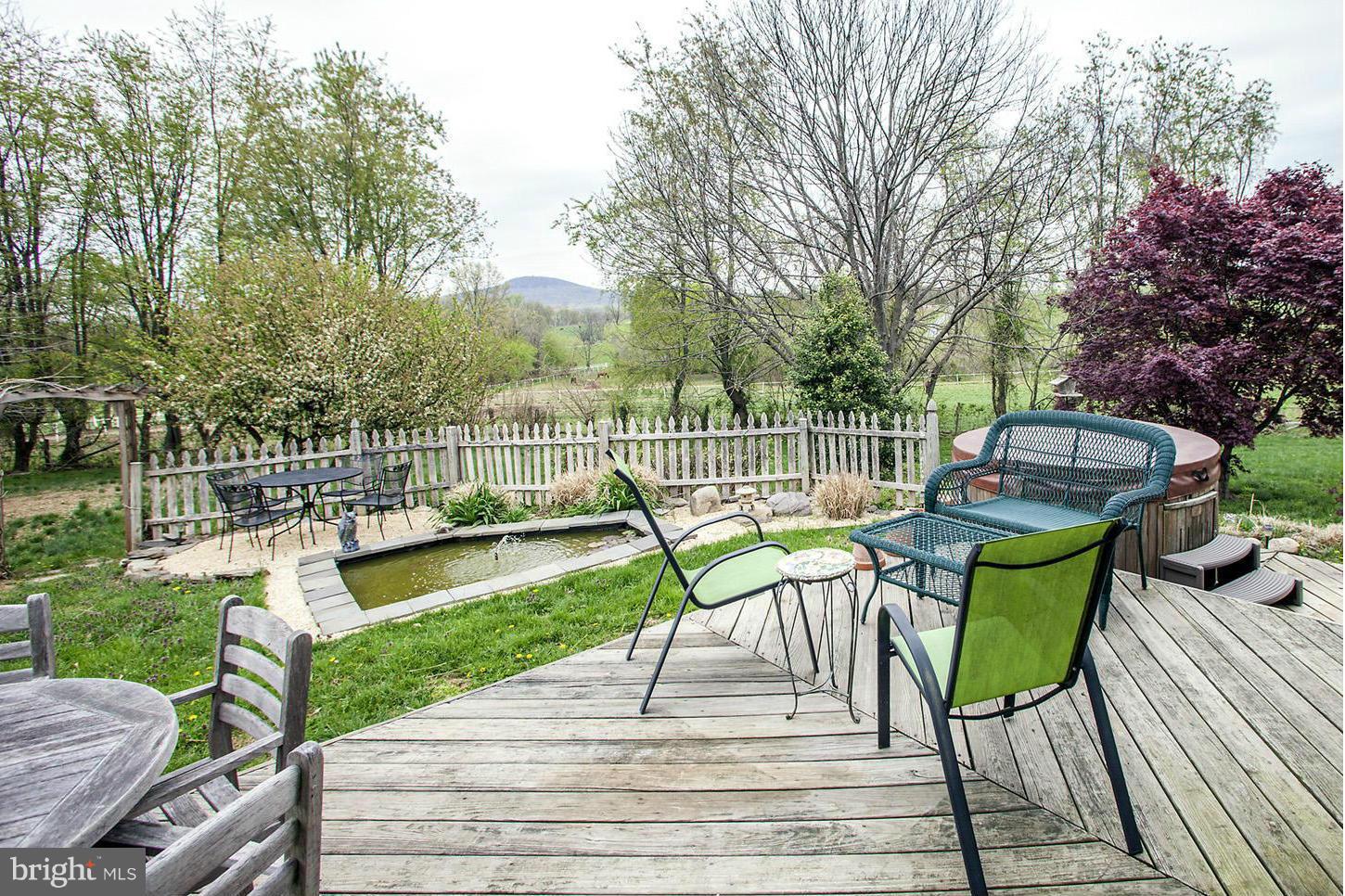 22316 West Harris Road Barnesville, MD 20838 - Photo 25 of 30 a view of a deck with chairs and a patio