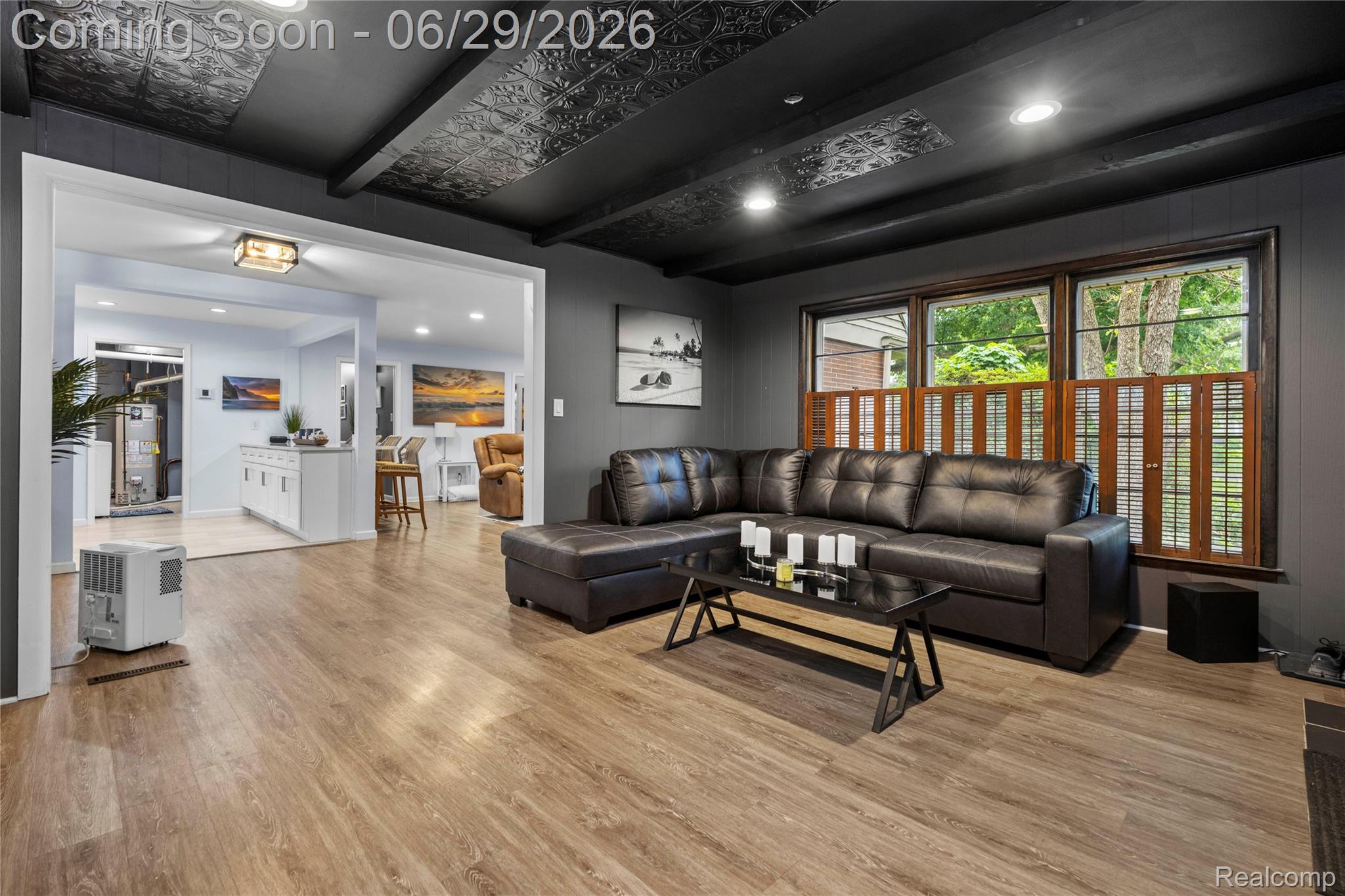 6085 Worlington Road Bloomfield Hills, MI 48301 - Photo 25 of 75 Spacious 2nd Living Room featuring wood-finish flooring, a decorative ceiling with exposed beams, and multiple large windows with wooden shutters