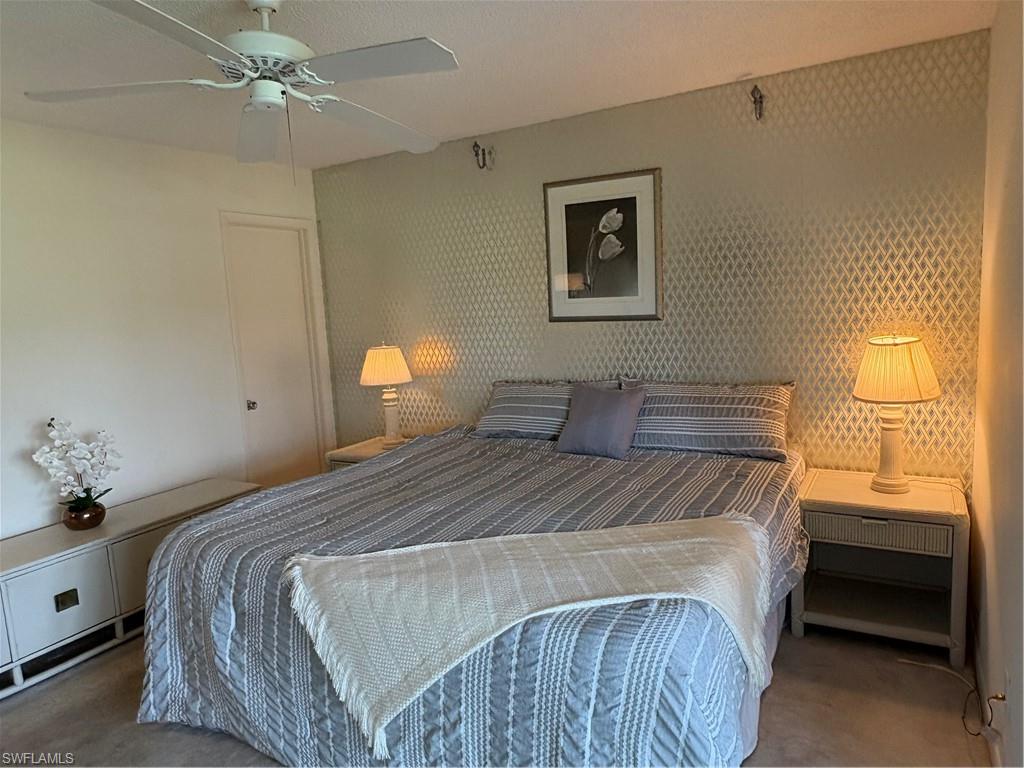 315 St Andrews Boulevard, Unit A2 Naples, FL 34113 - Photo 10 of 17 Bedroom featuring carpet flooring and ceiling fan