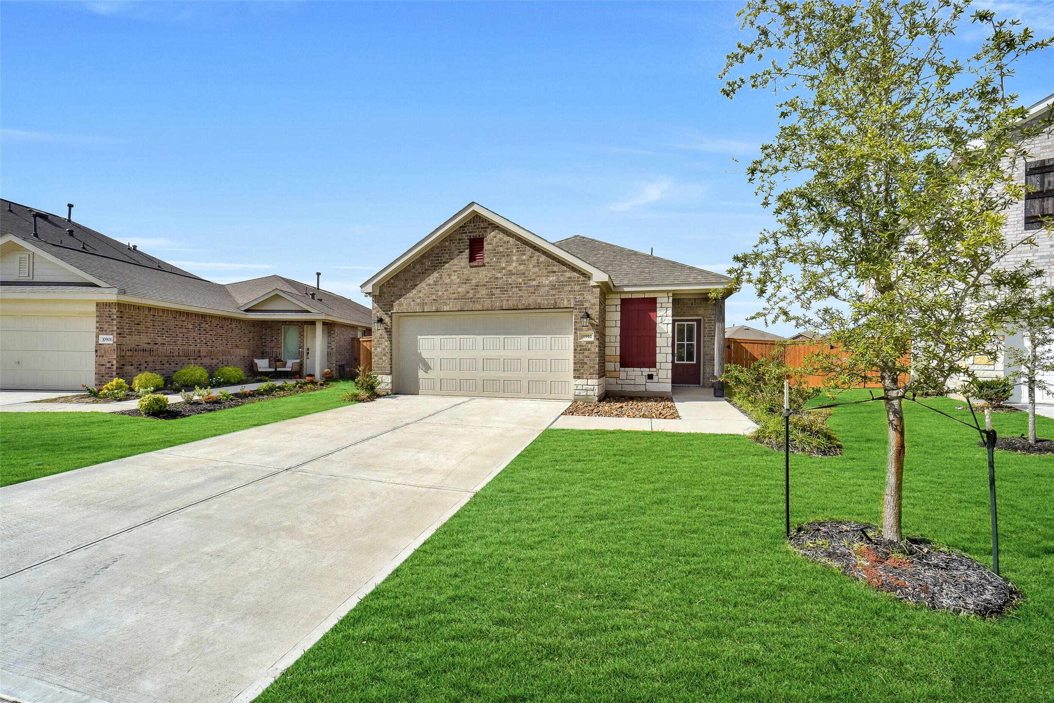 a front view of a house with a garden and trees