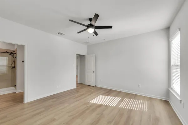 a view of a room with wooden floor and windows