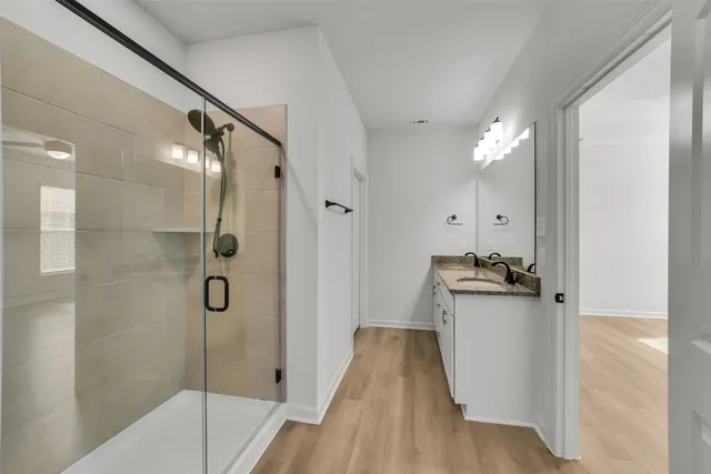 a bathroom with a tub sink and mirror