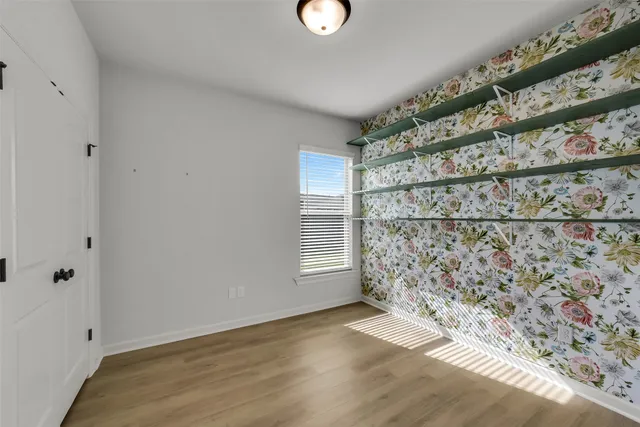 a view of wooden floor and windows in a room