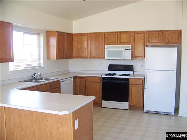 1170 Lattin Road Fallon, NV 89406 - Photo 3 of 6 a kitchen with a refrigerator and a sink