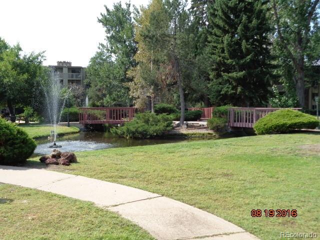 1302 South Parker Road, Unit 216 Denver, CO 80231 - Photo 9 of 13 a view of a garden with a bench