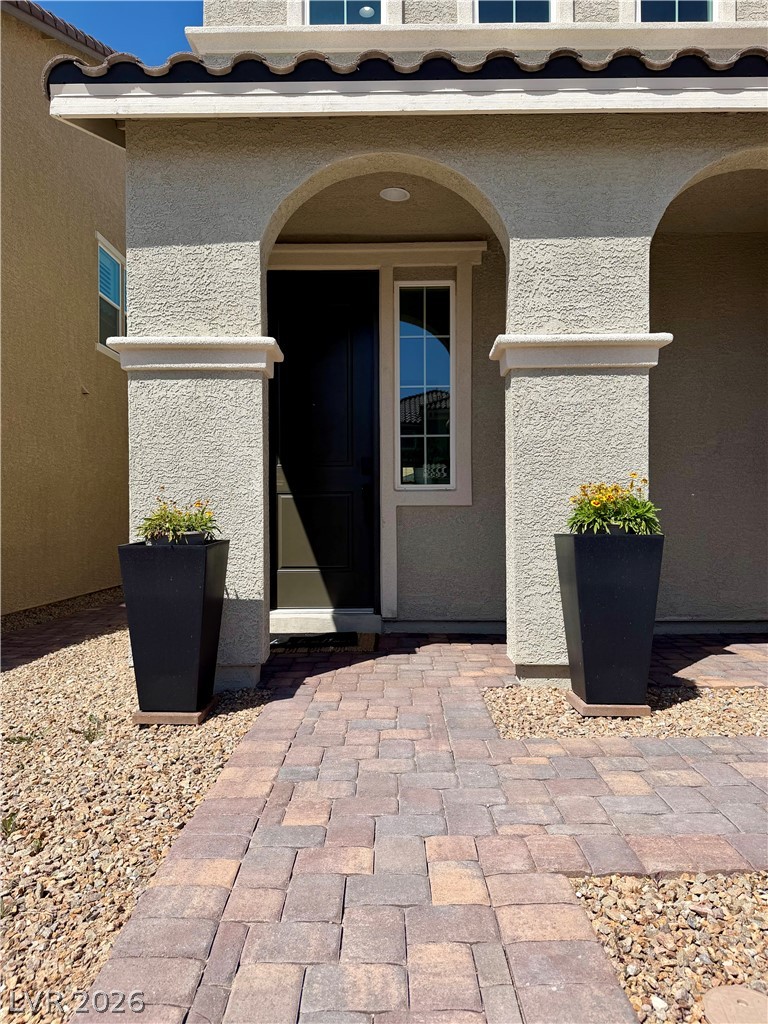6905 Diablo Rim Street North Las Vegas, NV 89086 - Photo 2 of 39 This inviting foyer features dual staircases and hardwood flooring, creating an open and airy welcome.