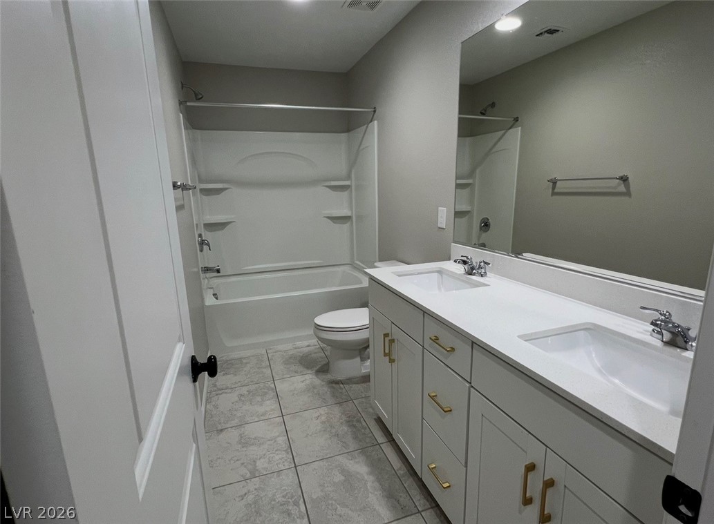 6905 Diablo Rim Street North Las Vegas, NV 89086 - Photo 31 of 39 This modern bathroom features dual sinks and a sleek shower-tub combination, providing comfort and utility.