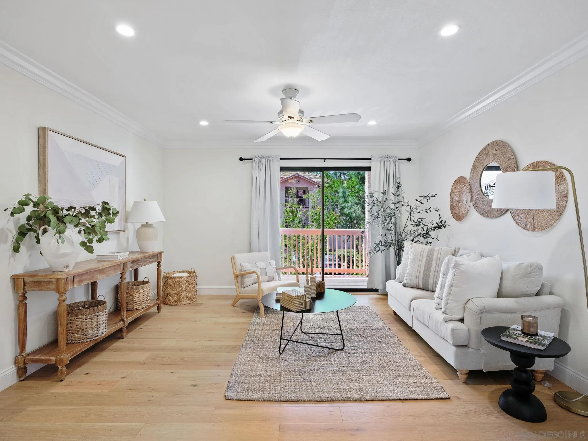 a living room with furniture a window and a chandelier