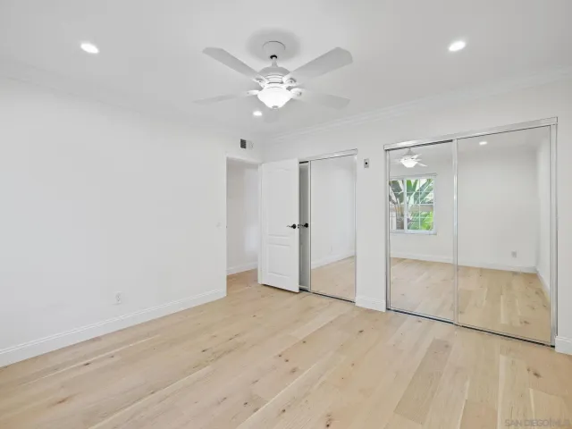 an empty space with wooden floor and entryway