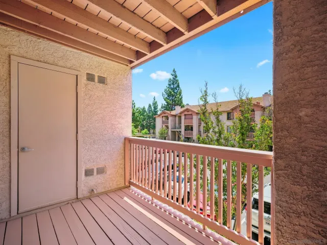 a view of balcony with wooden floor