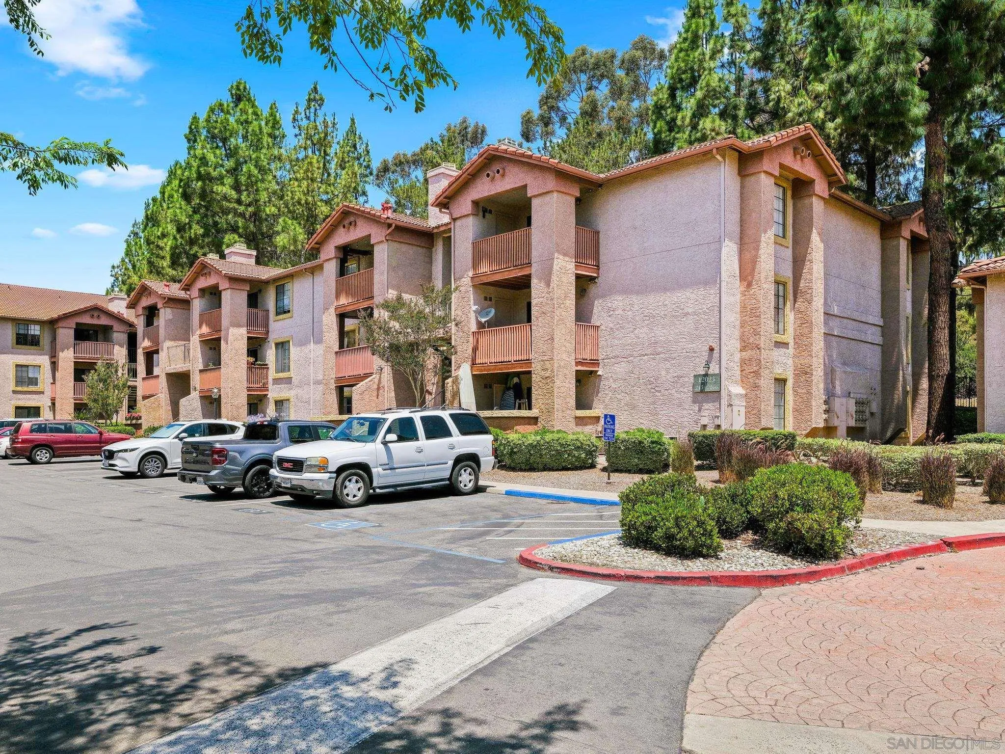 12023 Alta Carmel Court, Unit 244 San Diego, CA 92128 - Photo 2 of 16 a view of a car parked in front of a houses