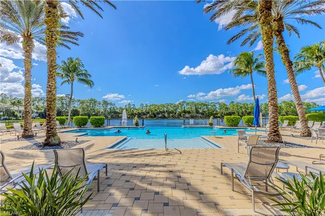 a view of swimming pool with outdoor seating and city view